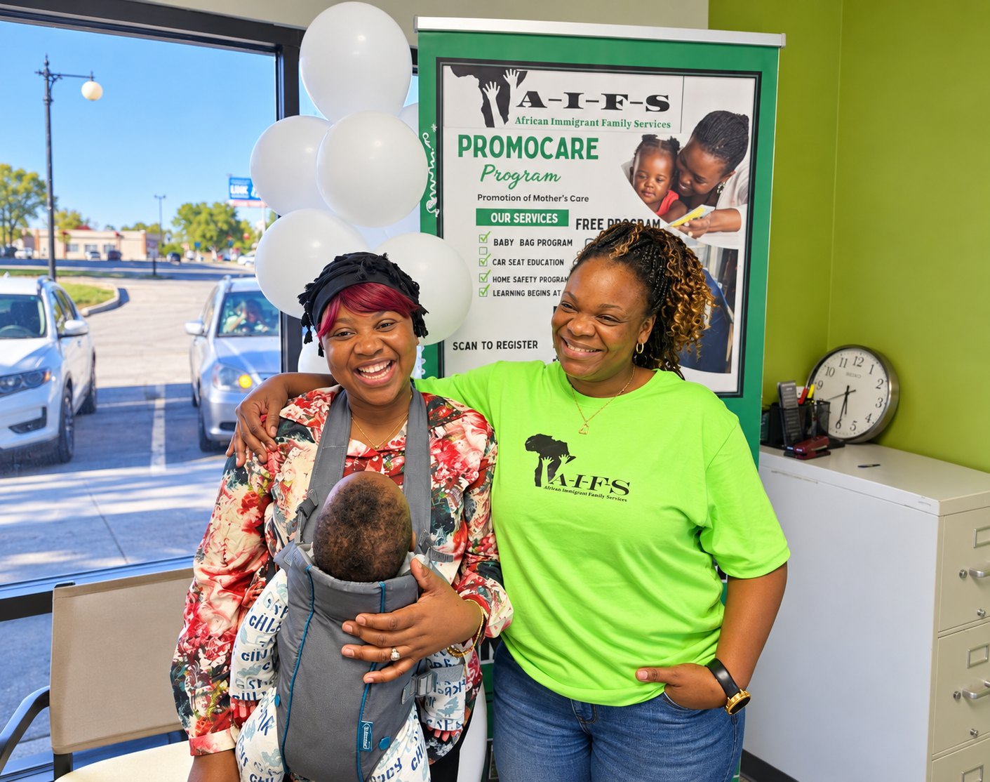A smiling mother carrying her baby with an AIFS staff member in front of the ProMoCare banner
